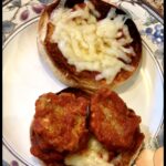 Delicious cheesy garlic bread topped with melted cheese and savory chicken meatballs on a decorative.